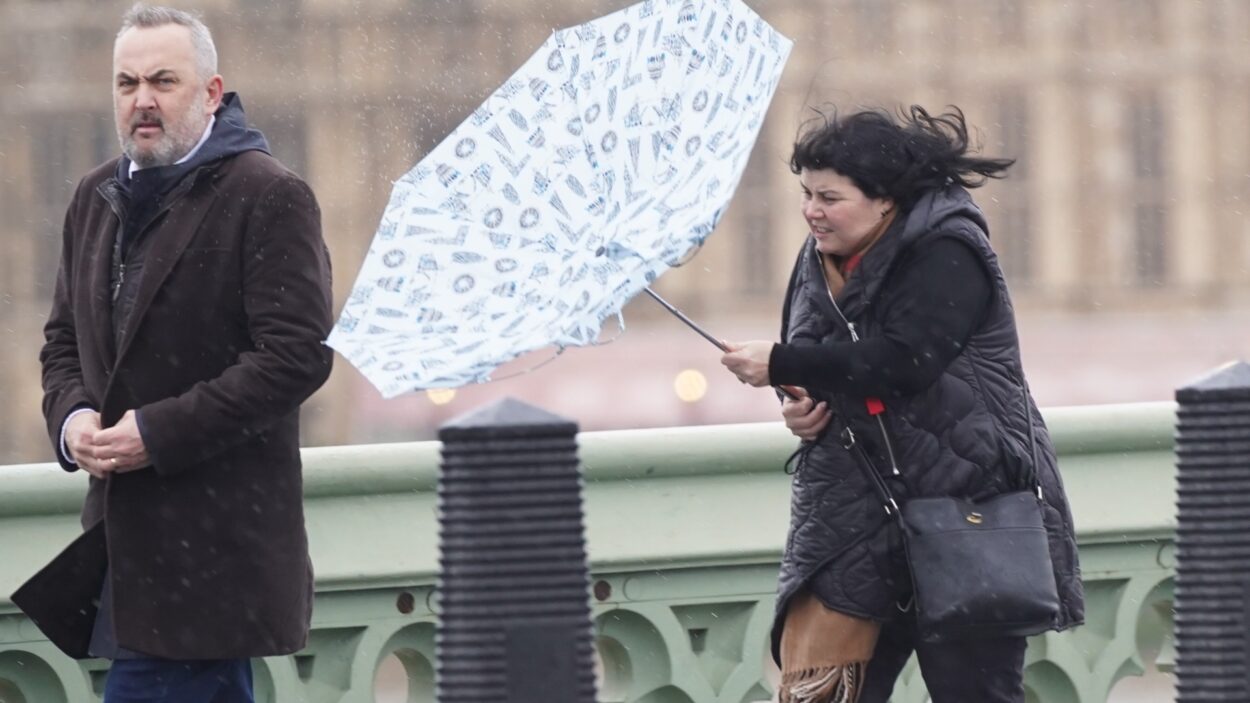 woman battles umbrella westminster bridge 712169102