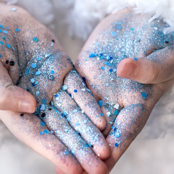 hands little girl blue sequins 703848834