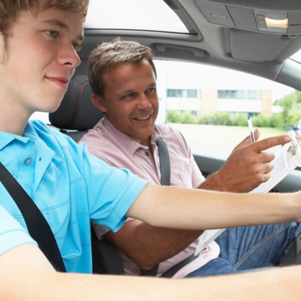 teenage boy taking driving lesson 759568169